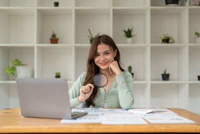 Young woman using laptop at table