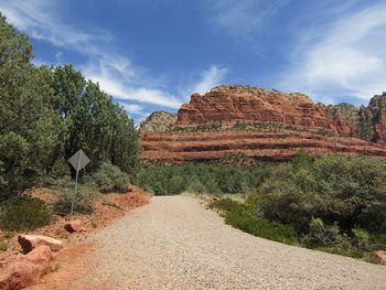 Panoramic view of dirt road to mountains 