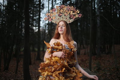 Portrait of young woman wearing headdress in forest