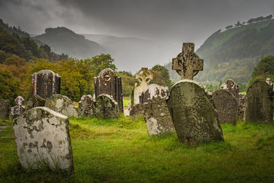 Ancient graves with celtic crosses in glendalough cemetery, ireland