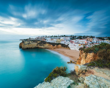 Village of carvoeiro and calm sea, high level view, algarve, portugal, europe