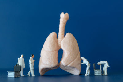 Close-up of figurine against blue background