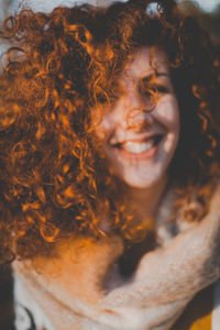 Close-up portrait of smiling young woman outdoors