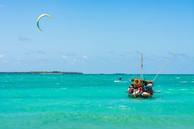 Group of people on a boat against sky