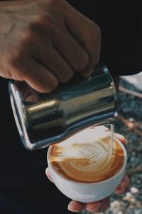 Cropped hand of man holding drink