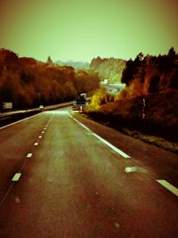 Empty road leading towards mountains