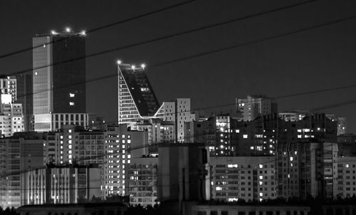 Low angle view of illuminated buildings against sky at night