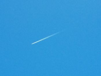 Vapor trail against clear blue sky