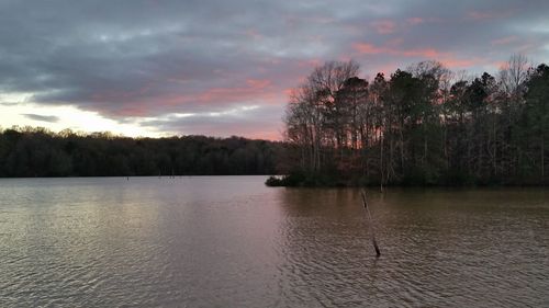 Scenic view of lake against cloudy sky