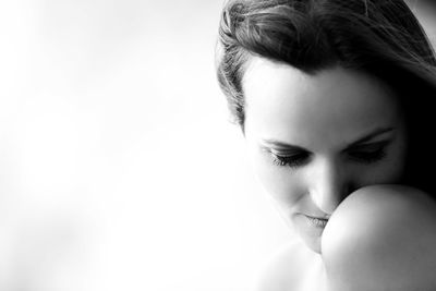 Portrait of young woman against white background