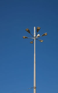Low angle view of street light against clear blue sky