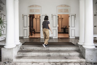 Woman walking into manour house style boutique hotel in colombo