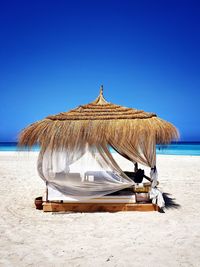  hut on beach against clear blue sky