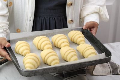 A woman prepare for baking. delicious traditional french crispy croissants, homemade bakery
