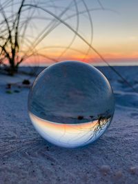 Close-up of crystal ball on beach
