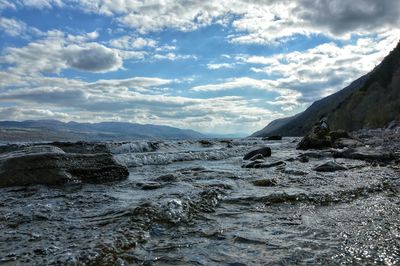 Scenic view of sea against cloudy sky