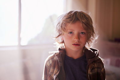 Portrait of boy standing at home