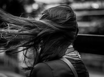 Close-up of woman with tousled hair outdoors