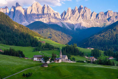 Scenic view of field and mountains against sky