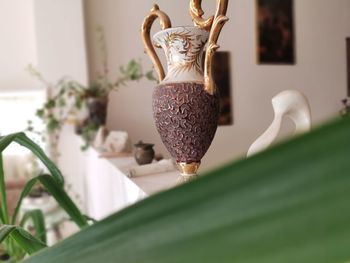 Close-up of figurine on table at home