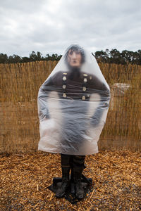 Woman standing on field against sky