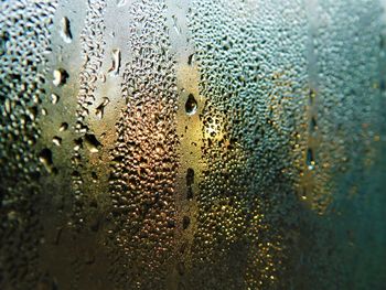 Full frame shot of raindrops on glass window