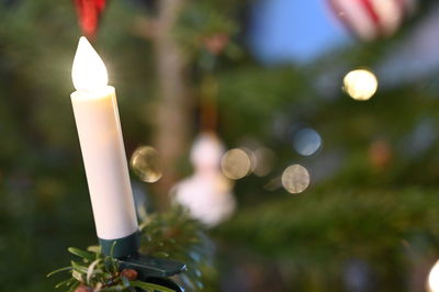 Close-up of lit candle against blurred background