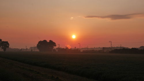 Scenic view of field against sky during sunset