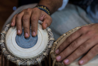 Midsection of man playing tabla