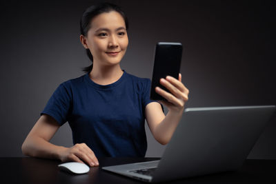 Portrait of mid adult man using smart phone