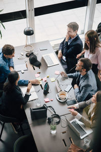 High angle view of business team planning at desk in creative office