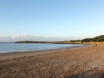 Scenic view of beach against clear sky