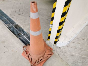 High angle view of yellow umbrella standing on footpath