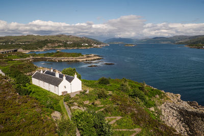 High angle view of sea and buildings against sky