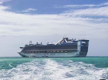 Ship sailing on sea against sky