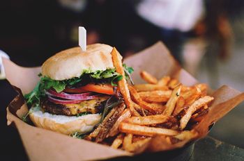 Close-up of burger with french fries on table