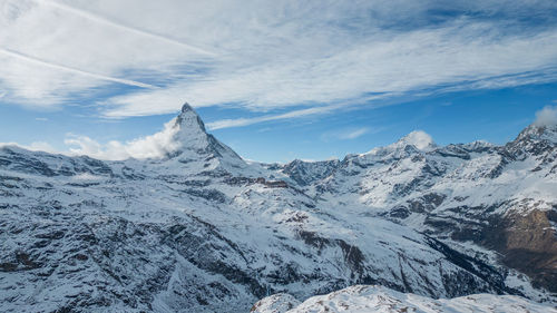 Scenic view of snowcapped mountains against sky