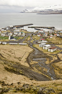 Vew from the mountains to the town, with the harbour, the little river and the sculptural church