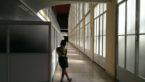 Silhouette of woman standing in corridor