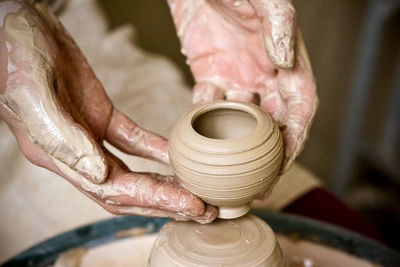 Master potter holding a cute little clay vase. ukraine, europe