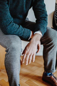 Low section of couple sitting