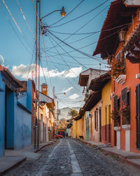 Street amidst buildings in town against sky