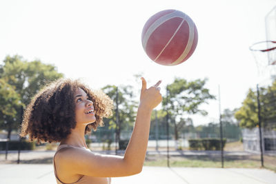 Young woman playing basketball