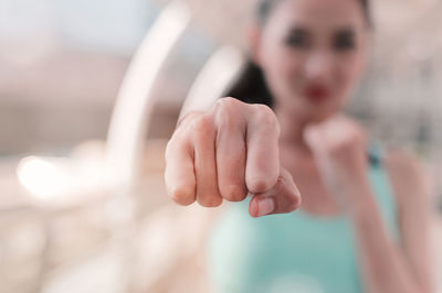 Close-up of young woman punching outdoors