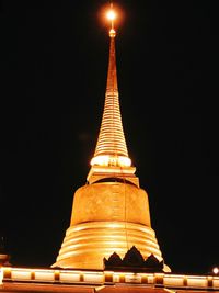 Low angle view of illuminated statue at night
