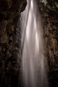 Scenic view of waterfall against sky