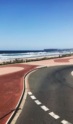 Scenic view of beach against clear blue sky