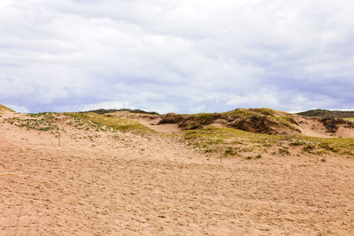 Scenic view of arid landscape against sky