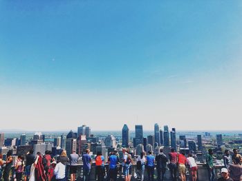 Panoramic view of crowd and buildings against sky