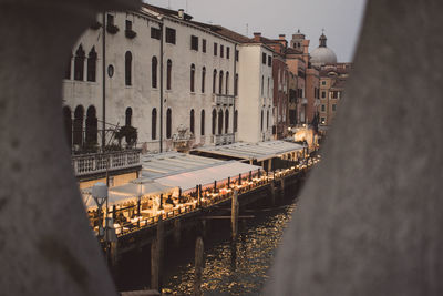 High angle view of canal by buildings in city